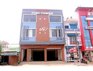 a building with a purporter sign on the side of it at Hotel UV, Haryana in Nārnaul