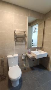 a bathroom with a white toilet and a sink at bali residensi in Malacca