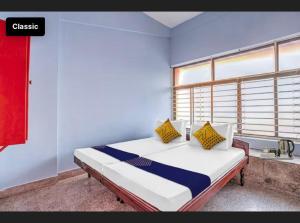 a bedroom with a bed with a window and a bed sidx sidx sidx at KKP Tourist Home in Trivandrum