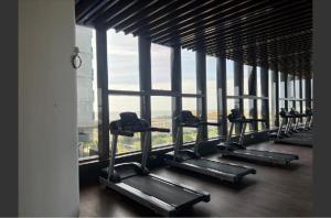 a row of treadmills in a building with a large window at bali residensi in Malacca
