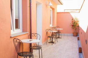 a row of tables and chairs on a patio at La Papaya in Marina di Pisa