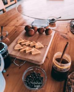 a wooden table with a cutting board with food on it at Umutuzo lodge Kivu lake 