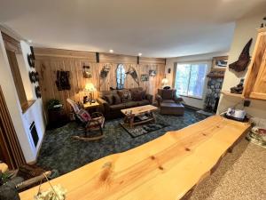 a living room with a large wooden table in it at 141 Premium Condo in Mammoth Lakes