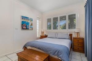 a bedroom with a bed and two windows at Breakers 2 213 East Street in Crescent Head +14 photos