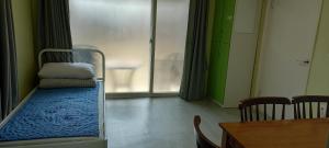 a hospital room with a bed and a table and chairs at Hans House in Seoul