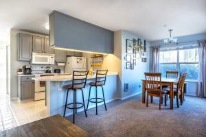 a kitchen with a table and some chairs in a room at Alleys 22 with Direct Deck Access in Hood River
