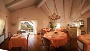 a dining room with tables and chairs and a chandelier at Marcarini Agriturismo in Neviglie
