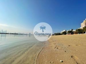 a balloon on a beach with the words happy birthday at Harmony Vacation Homes - BALQIS Residence in Dubai