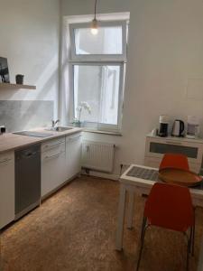 kuchnia ze stołem, umywalką i oknem w obiekcie studio g -Central sunny apartment for 6 guests with terrace w mieście Düsseldorf