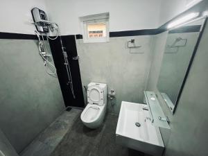 a bathroom with a toilet and a sink at The Lake Round Guest House in Kandy