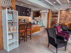 a restaurant with chairs and a counter in a store at The Siam Heritage Hotel in Bangkok