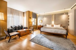 a hotel room with a bed and a couch at Ansen Hotel and Suites in Istanbul