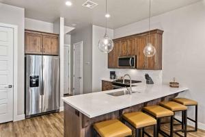 a kitchen with a sink and a counter with stools at Red Mountain Springs #23 townhouse in Santa Clara