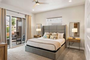 a bedroom with a large bed and a balcony at Red Mountain Springs #23 townhouse in Santa Clara