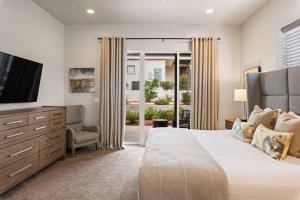 a bedroom with a large bed and a television at Red Mountain Springs #23 townhouse in Santa Clara +45 photos