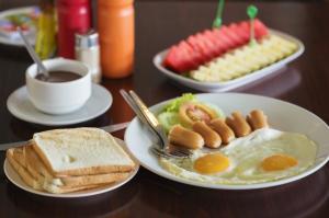a table with plates of breakfast foods and a cup of coffee at Crowne Plaza Dalian Xinghai, an IHG Hotel in Dalian