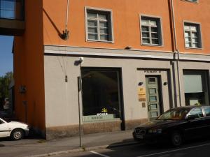 a store front with a car parked in front of it at Kotimaailma Apartments Vaasa in Vaasa