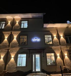 a building with a lit up sign on the side of it at Bay Ali in Tölöykön