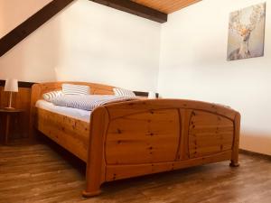 a wooden bed in a corner of a room at Ferienhaus Geiger in Bernau im Schwarzwald in Bernau im Schwarzwald