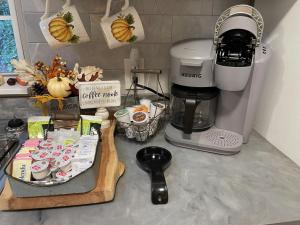 a kitchen counter with a coffee maker and a tray of food at Twin Ponds Retreats retreat in Whittier