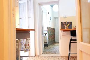 a hallway with a door to a kitchen with a table at Vita in Catania