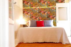 a bedroom with a large bed with a floral wallpaper at Vita in Catania