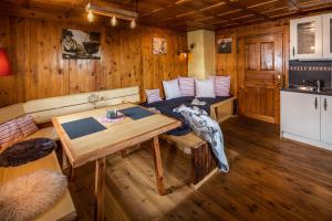 a room with a couch and a table in a cabin at Haus Guglprasta in Sankt Veit in Defereggen