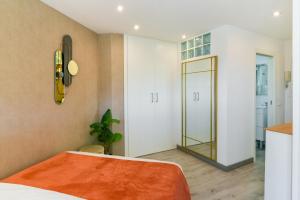 a bedroom with a bed and a mirror on the wall at Apartamento a un paso del mar in Málaga