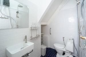 a white bathroom with a sink and a toilet at Townhome w/ workstation-2mins to food-fun-metro in Bangkok