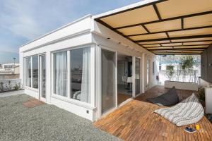 a room with sliding glass doors on a balcony at Port de L'eau Roof Garden in Thessaloniki