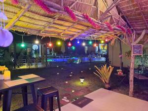 a patio with tables and chairs in a building at Residence M Thailand, Resort, Mae Ramphueng Beach, Ban Phe, Rayong, Residence M Thailand in Ban Chamrung