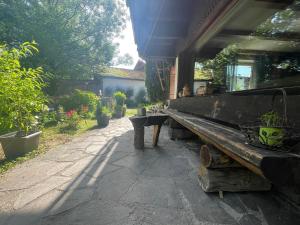 a wooden bench sitting on a sidewalk in a garden at Haus am Bach in Erl
