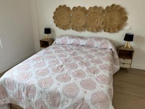 a bedroom with a bed and two tables with lamps at Ático a estrenar Ribamontán-Mar in Hoznayo +36 photos