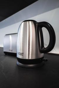 a black and silver coffee cup sitting on a counter at Large Seafront Maisonette in St Paul's Bay