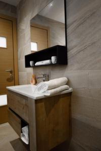 a bathroom with a sink and a mirror at Large Seafront Maisonette in St Paul's Bay