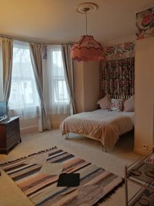 a bedroom with a bed and a large window at Avon Guesthouse in Bath