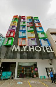 M.Y. Hotel في دوماغيتي: مبنى كبير مع نوافذ ملونة وعلامة عليه