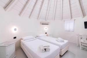 Cama ou camas em um quarto em Porto Mykonos