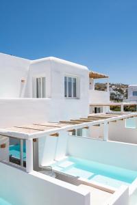 a white house with a swimming pool on the roof at Porto Mykonos in Mikonos