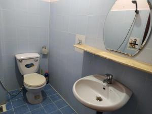 a bathroom with a toilet and a sink and a mirror at Entire small house mins to everywhere! in Ho Chi Minh City