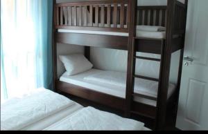 two bunk beds in a room with a window at Apartments La Rosa in Rust