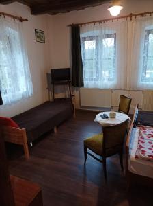 a bedroom with a bed and a table and chairs at Kemencés Vendégház in Mikóháza