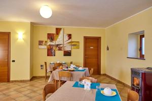a dining room with two tables and chairs at Al Casale B&B in Cherasco