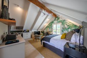 a bedroom with a bed and a desk with a computer at Dornoch on Gowrie Farm, Nottingham Road in Nottingham Road