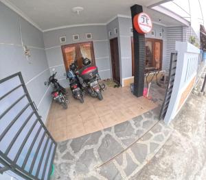an overhead view of two motorcycles parked in a garage at JE Homestay Jogja in Sentool
