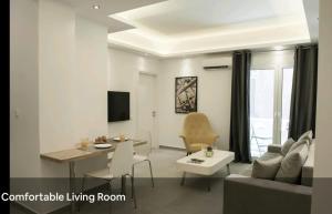 a living room with a couch and a table at SYNTAGMA VOULIS STREET MODERN APARTMENT in Athens