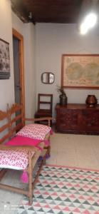 a room with a wooden chair and a table at Albergue Armaia Artepea in Urzainqui