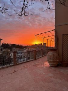 a sunset over a balcony with a fence at Castellinaria in Lari