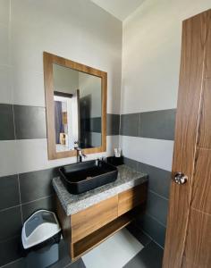 a bathroom with a black sink and a mirror at Trường Phúc Vinh Hotel in Phan Thiet