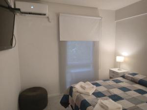a small bedroom with a bed and a window at A 2 minutos caminando de la terminal. in Salta